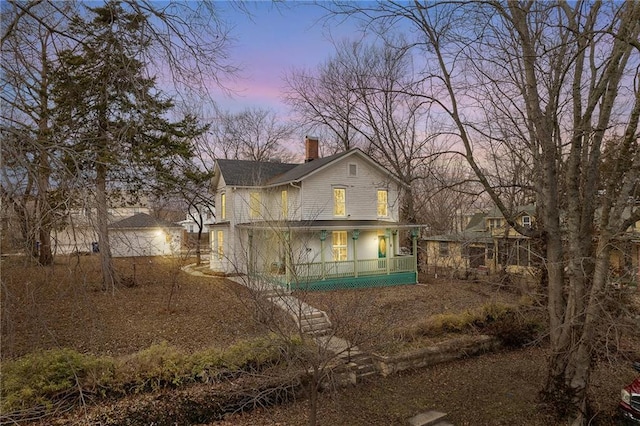 view of back house at dusk