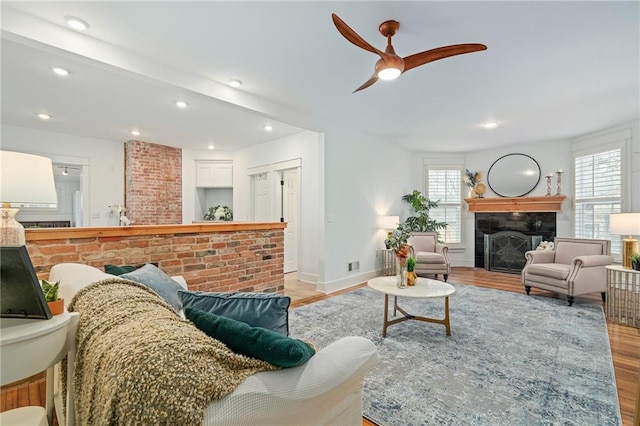 living room with ceiling fan and light wood-type flooring