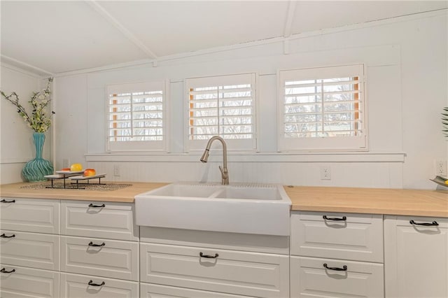 kitchen featuring sink and white cabinets