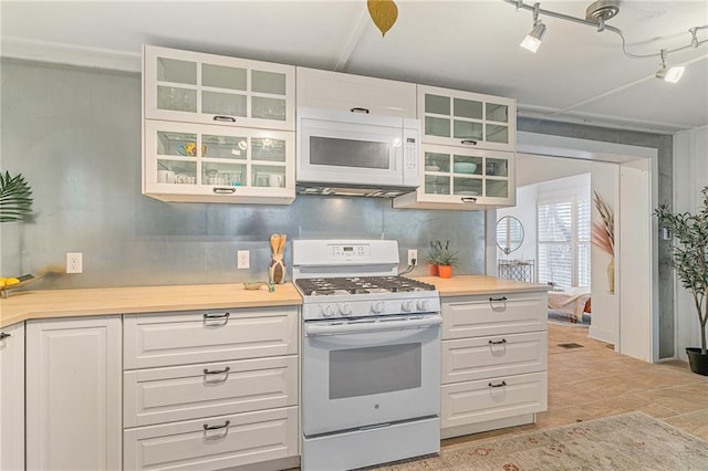 kitchen featuring white appliances and white cabinets