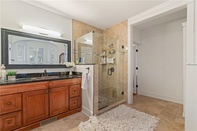 bathroom with vanity and a shower with shower door