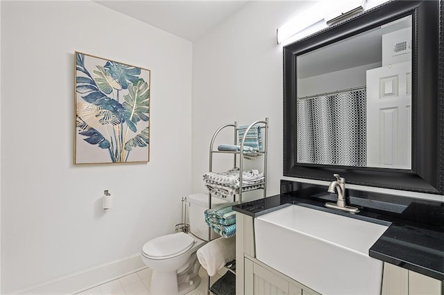 bathroom with vanity, tile patterned floors, and toilet