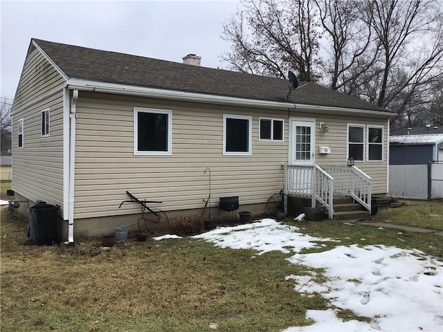 snow covered property with a lawn