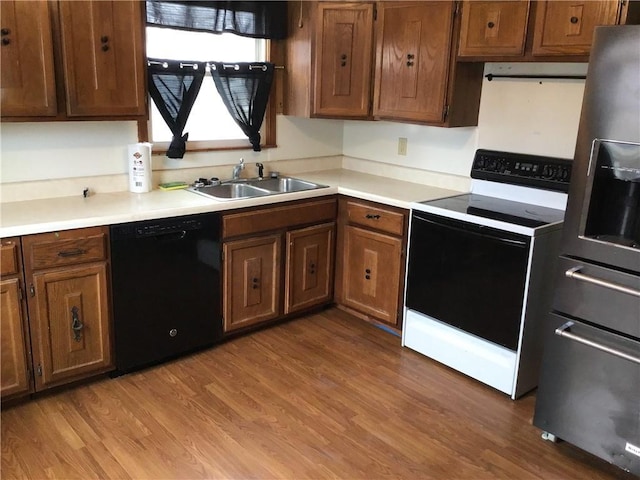 kitchen featuring hardwood / wood-style floors, black dishwasher, sink, electric range, and stainless steel fridge with ice dispenser