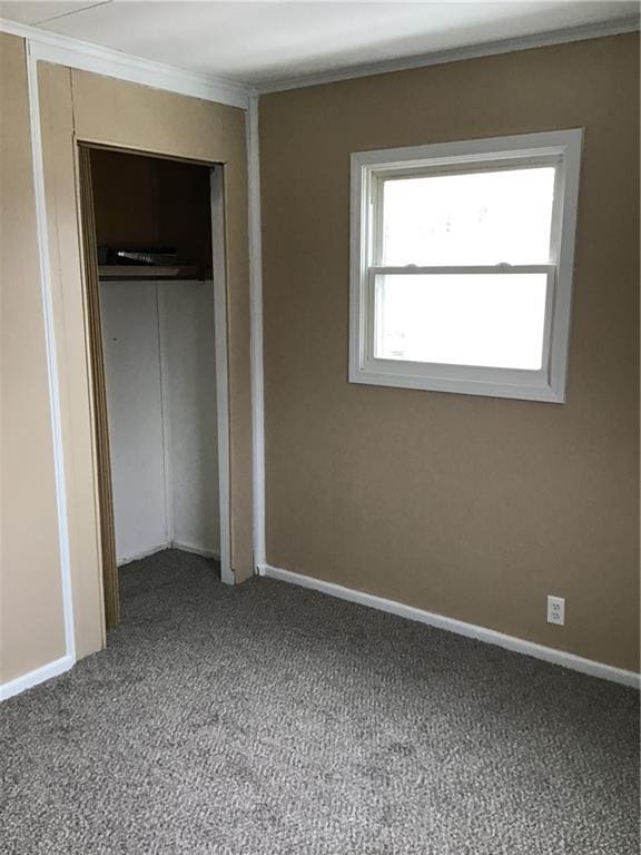 unfurnished bedroom featuring carpet flooring and a closet