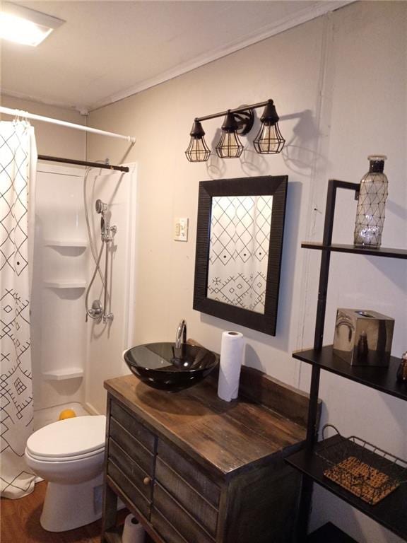 bathroom featuring crown molding, hardwood / wood-style floors, vanity, curtained shower, and toilet