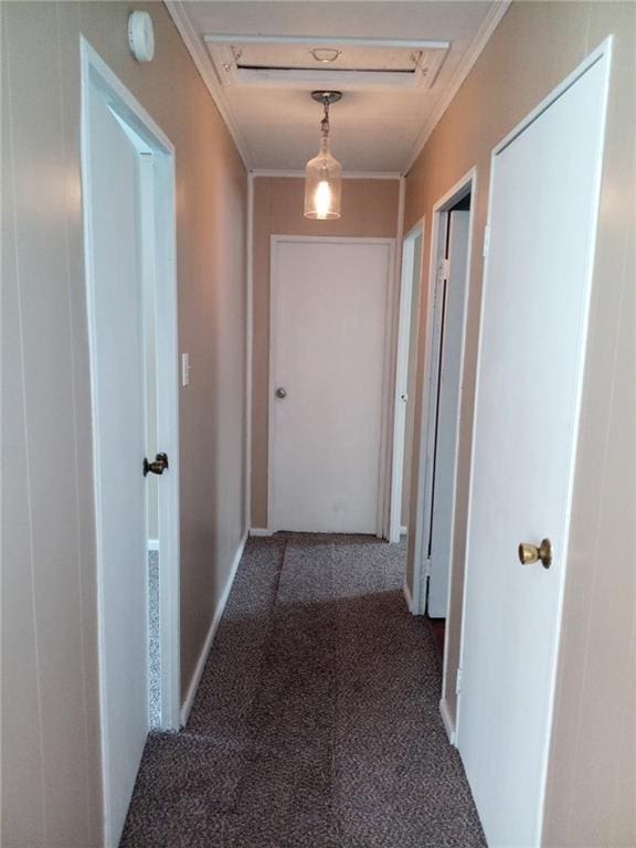 corridor featuring dark carpet and ornamental molding