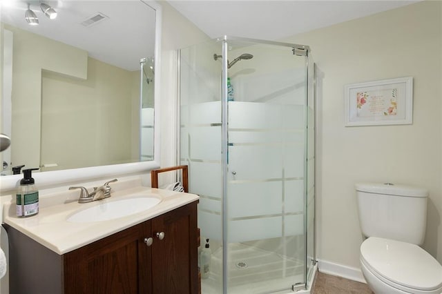 bathroom featuring vanity, toilet, tile patterned floors, and walk in shower