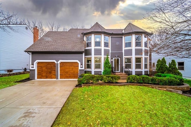 view of front of property featuring a garage and a yard