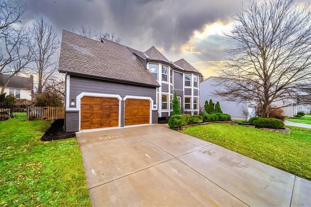 view of front of property featuring a garage and a yard