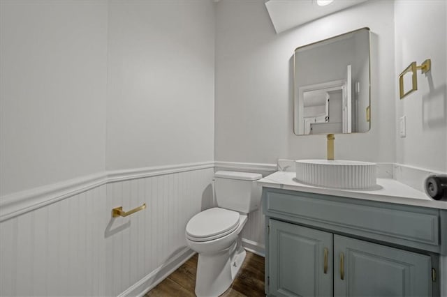 bathroom featuring vanity, toilet, and hardwood / wood-style floors