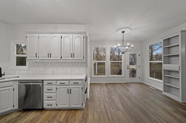 kitchen featuring decorative light fixtures, dishwasher, white cabinets, a chandelier, and dark wood-type flooring