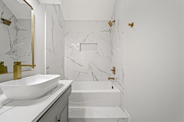 bathroom with vanity and tiled shower / bath combo