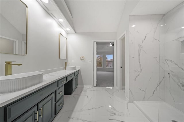 bathroom featuring vanity, vaulted ceiling, tiled shower, and ceiling fan