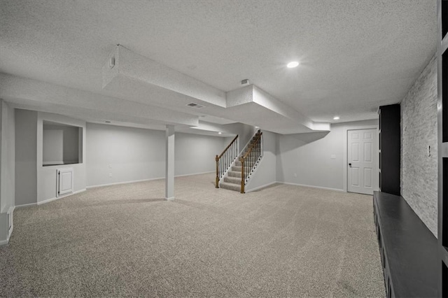 basement featuring carpet floors and a textured ceiling