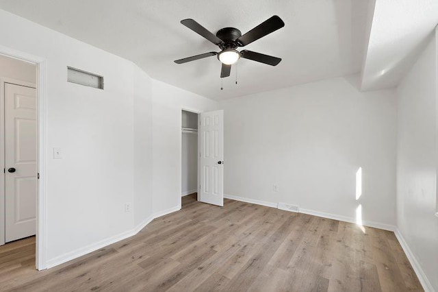 unfurnished bedroom with light hardwood / wood-style floors, a closet, and ceiling fan