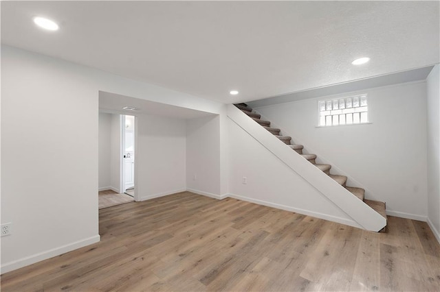 basement featuring light hardwood / wood-style floors