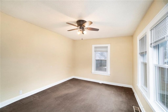 carpeted empty room featuring ceiling fan