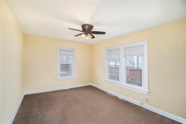 carpeted spare room with ceiling fan