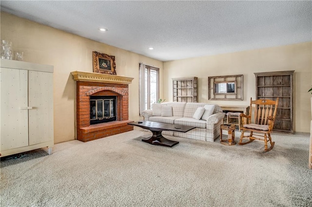 carpeted living room featuring a textured ceiling and a fireplace