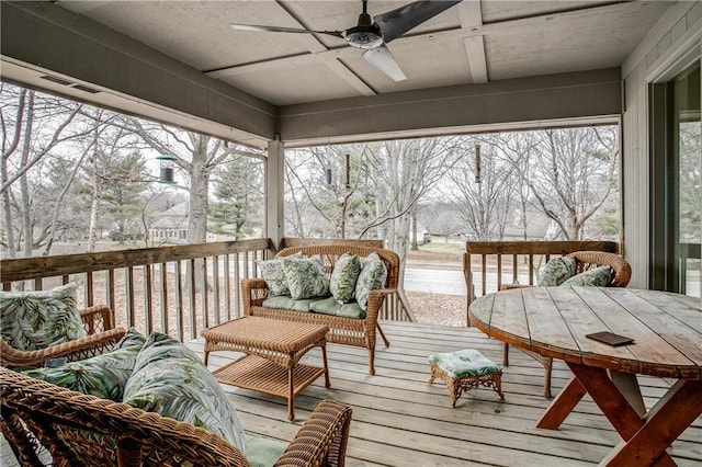 sunroom / solarium featuring ceiling fan