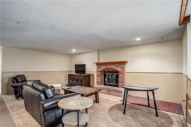 carpeted living room featuring a fireplace and a textured ceiling