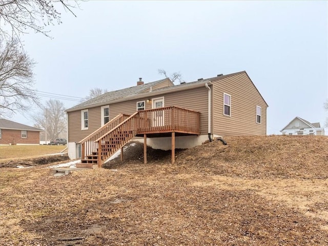 rear view of property featuring a deck