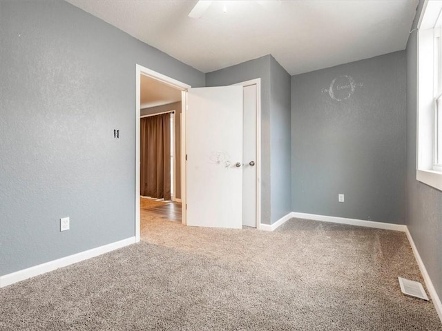 unfurnished bedroom featuring a closet, ceiling fan, and carpet flooring