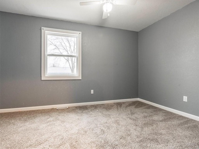 carpeted empty room featuring ceiling fan