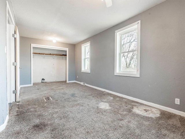 unfurnished bedroom with a closet and carpet flooring