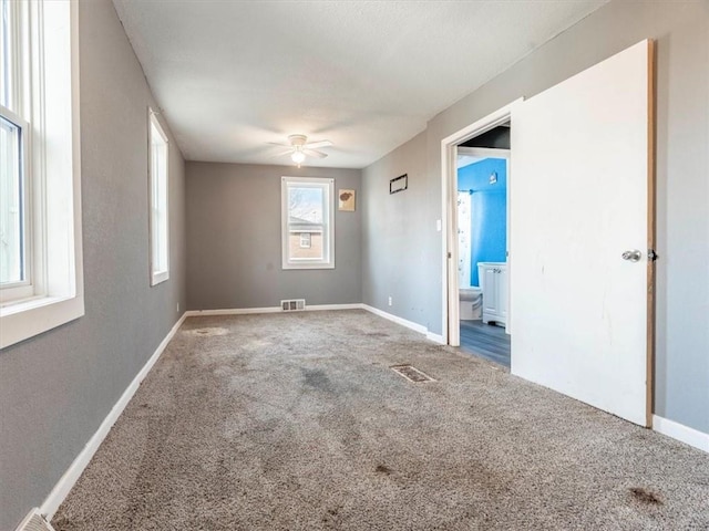 empty room featuring ceiling fan and carpet floors