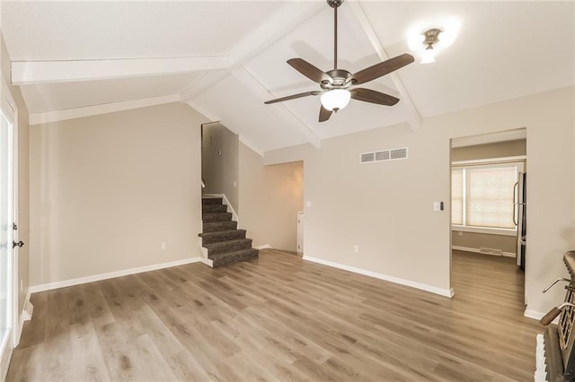 unfurnished living room with vaulted ceiling with beams, hardwood / wood-style flooring, and ceiling fan