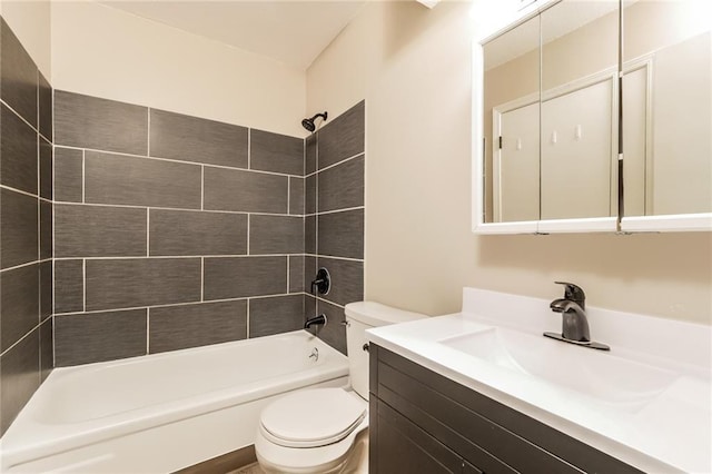 full bathroom with tiled shower / bath, vanity, and toilet