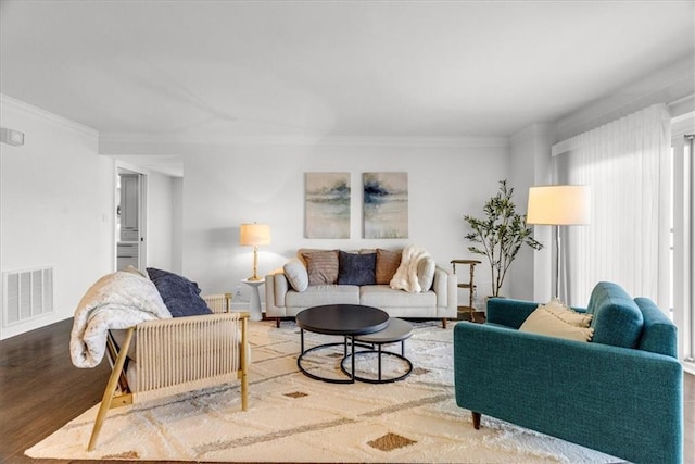 living room featuring wood-type flooring and ornamental molding