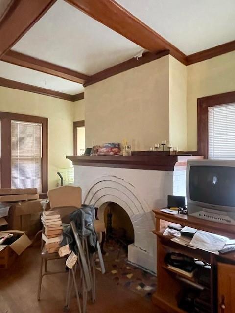 interior space with crown molding and beam ceiling