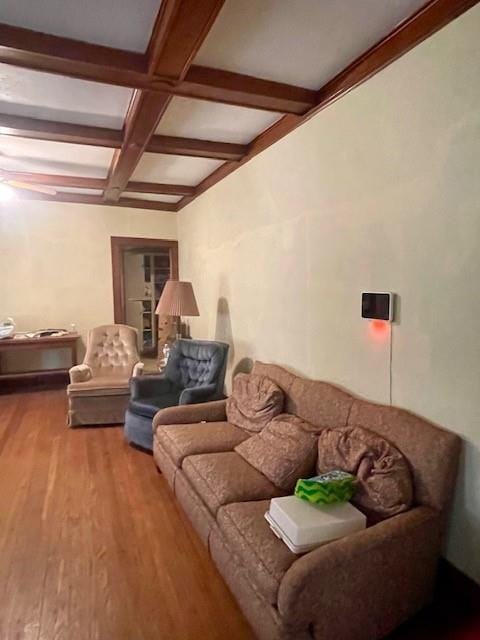 living room featuring beam ceiling, coffered ceiling, and light wood-type flooring