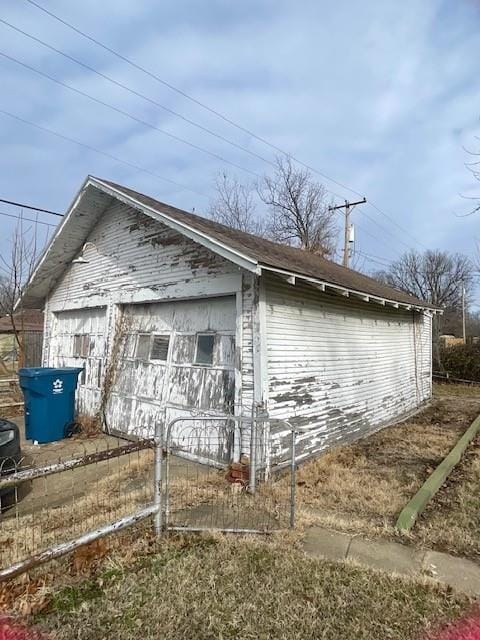 view of side of home featuring a garage and an outdoor structure