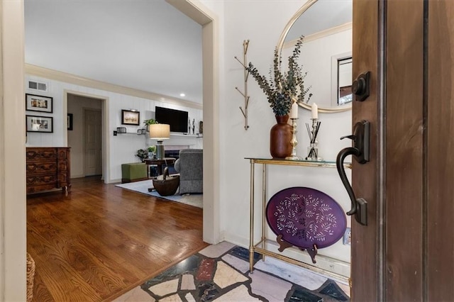 entryway featuring hardwood / wood-style floors and ornamental molding