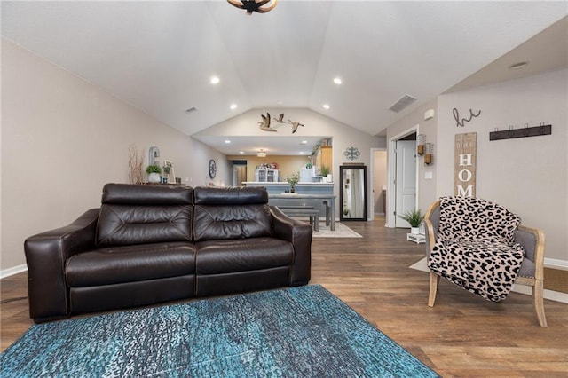 living room with hardwood / wood-style flooring and vaulted ceiling