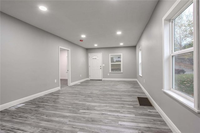 unfurnished room with light wood-type flooring