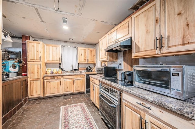 kitchen with stainless steel appliances, sink, light stone counters, and light brown cabinetry