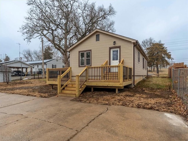 rear view of property featuring a wooden deck