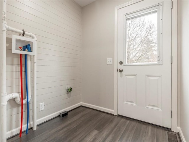 washroom with dark hardwood / wood-style flooring and washer hookup