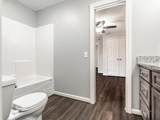 full bathroom featuring toilet, ceiling fan, shower / bathtub combination, vanity, and wood-type flooring