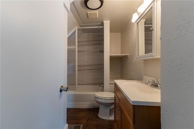 full bathroom featuring vanity, wood-type flooring, washtub / shower combination, and toilet