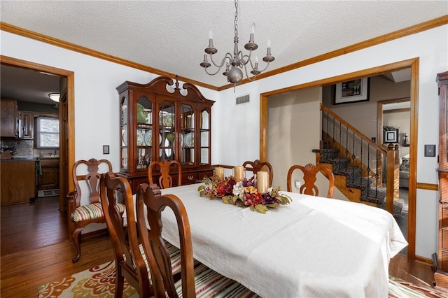 dining space with visible vents, ornamental molding, dark wood-style flooring, stairs, and a chandelier