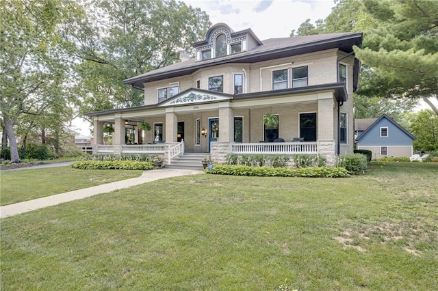 view of front facade with covered porch and a front lawn