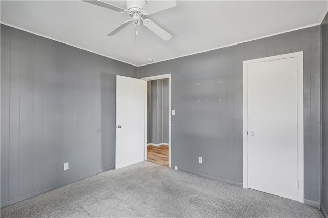 empty room featuring light carpet and ceiling fan