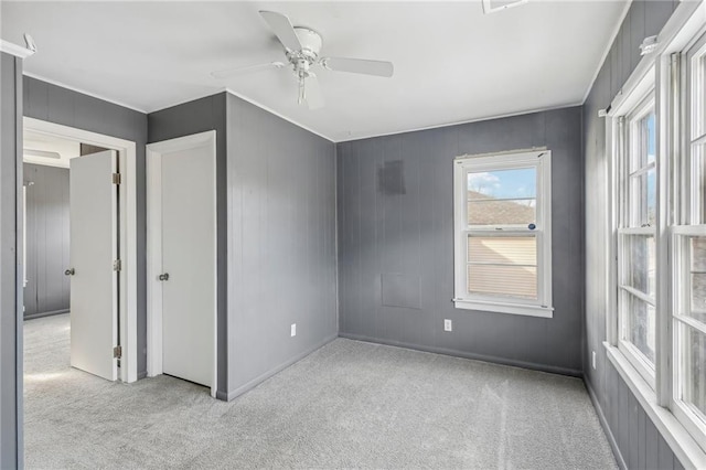 unfurnished bedroom with ceiling fan and light colored carpet