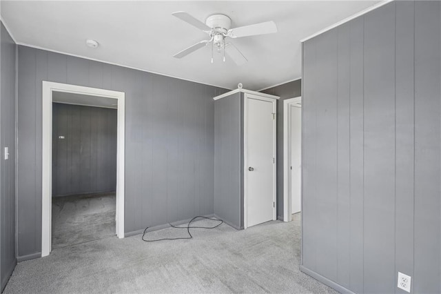 unfurnished bedroom featuring ceiling fan and light colored carpet